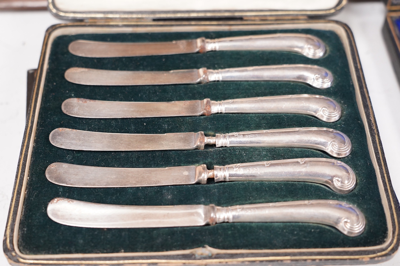 A cased set of six silver handled tea knives and six other cased plated sets. Condition - fair